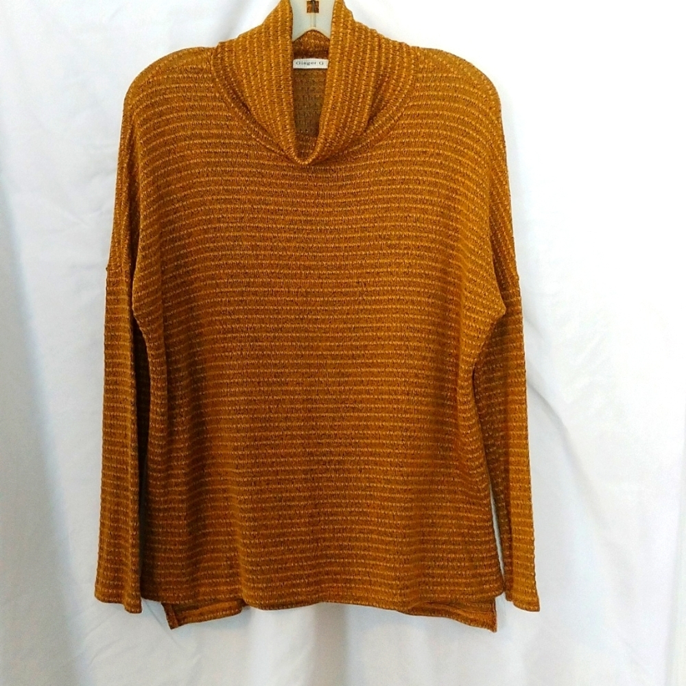Gold Ginger G turtleneck sweater.